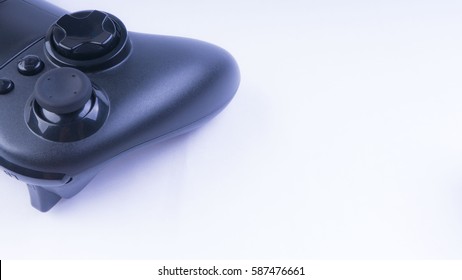 Closeup of black game controller isolated on white background.