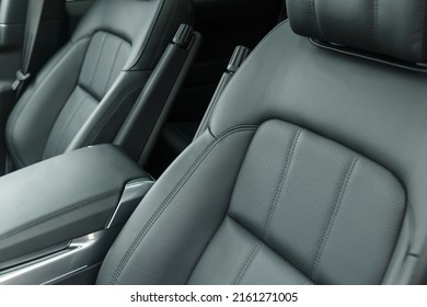 Close-up of a black genuine leather driver's seat with a folding armrest. Place for the logo. Beautiful leather car interior design. Luxury leather seats in the car. - Shutterstock ID 2161271005