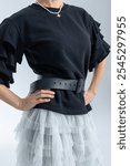 Close-up of black leather belt on model. High fashion. Vertical photo. High quality photo