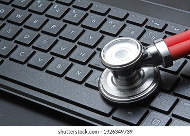 Close-up Of Black Modern Computer Keyboard. Stethoscope On Doctor Table Or Nurse Desk.