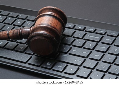 Close-up Of Black Modern Computer Keyboard. Gavel On Table Desk.