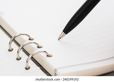 closeup black pen on business a book - Shutterstock ID 240199192