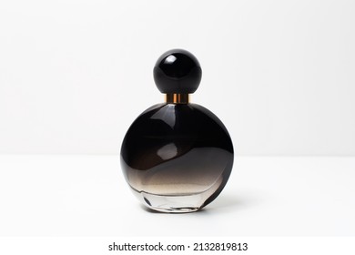 Close-up Of Black Perfume Bottle On White Background.