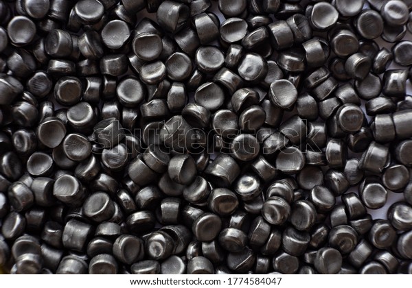 Close-up of black plastic polymer granules.\
polymer plastic. compound\
polymer.