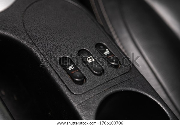close-up of black of seat heating buttons on car\
panel, no trade\
marks\
