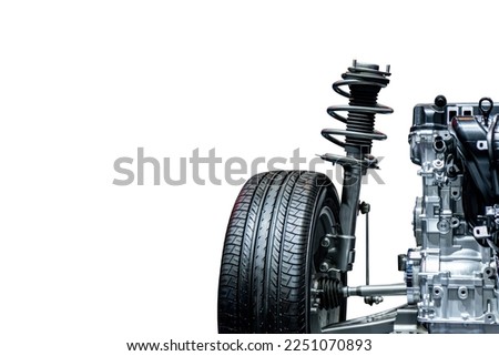 Closeup of black shock absorber and spring with wheel isolated on a white background with clipping path. Spare parts for passenger cars for education.