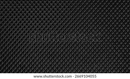 Close-up of a black textured surface with repeating diamond pattern, creating a modern and industrial feel. Perfect for abstract backgrounds or digital design