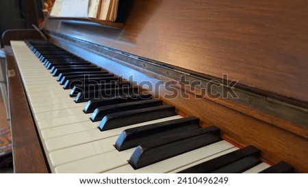 Close-up of black and white keys of an old wooden piano. Vintage piano keyboard, selective focus, Music background.