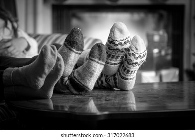 Closeup Black And White Photo Family Wearing Woolen Socks Warming At Fireplace