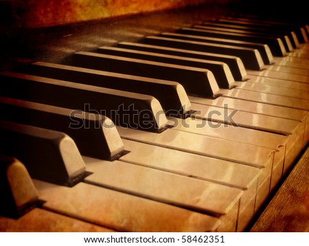 Closeup of black and white piano keys and wood grain with sepia tone