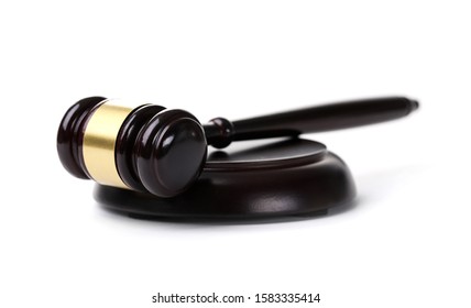 Close-up Of Black Wooden Gavel Laying On Sounding Block With Golden Strip. Attorney And Notary Stuff. Justice And Law Concept. Isolated On White Background