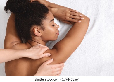 Closeup Of Black Young Woman Having Healing Body Massage, White Background, Top View, Free Space