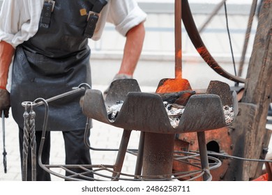 Close-up of a blacksmith working with a blazing forge fire at a historical workshop in Lithuania, 2023. Showcasing traditional metalworking skills - Powered by Shutterstock