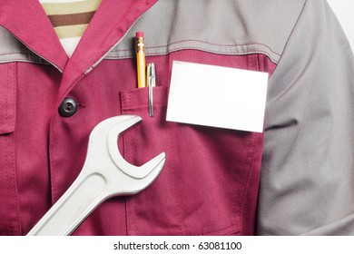 Close-up Of Blank Name Tag On Service Man Uniform And Big Wrench