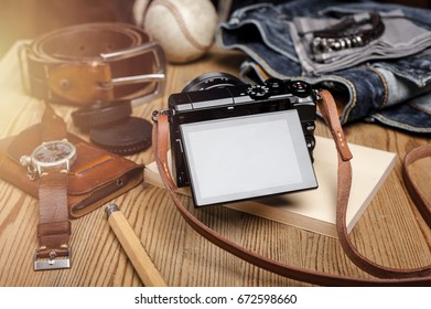 closeup blank screen of digital mirrorless camera with leather strap.