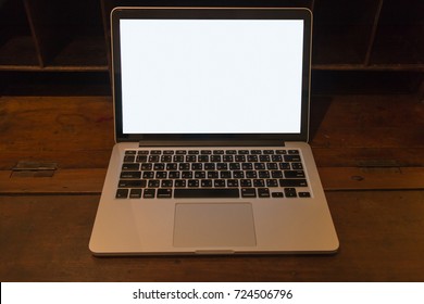 Closeup blank or white screen computer laptop on vintage wooden desk, concept of home work place