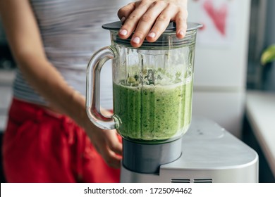 .Close-up blender process. Cooking a green spring smoothie. Mixing in a blender bowl. - Shutterstock ID 1725094462