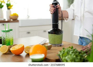 Close-up Of The Blender Process. I'm Making A Green Smoothie With Whitgrass. Mixing In A Blender Bowl.