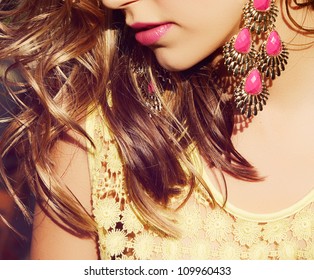 Closeup Of Blond Woman With Long Wet Curly Hair Wearing Pink Lipstick And Gold And Pink Neon Earrings