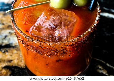 A close-up of a bloody mary type drink or cocktail.  