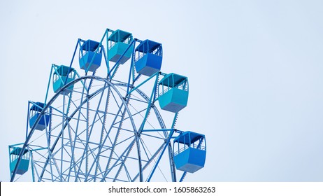  Close-up Blue booths of damn wheel are covered in frost in winter time, against blue sky with copy space. - Powered by Shutterstock