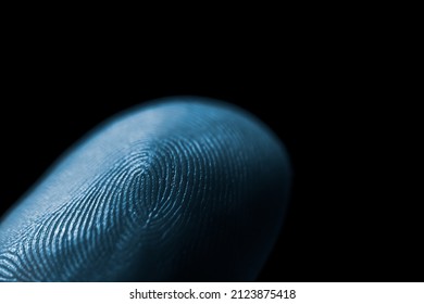 Close-up of blue color fingerprint texture of finger skin