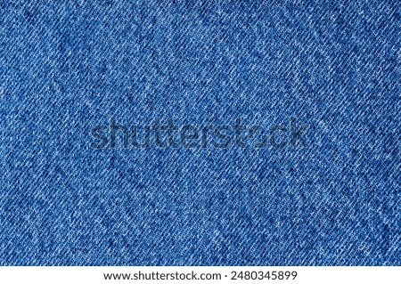 A close-up of a blue denim jeans jacket