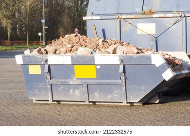Closeup of a blue dumpster with construction waste in the Netherlands