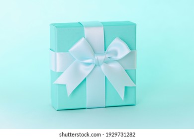 Closeup in blue gift box with beautiful ribbon. Designer gift wrapping concept