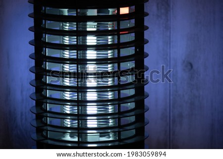 Close-up of a blue glowing bug zapper