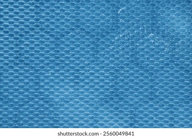 Close-up of blue honeycomb hexagonal patterned material. Abstract texture, suitable for backgrounds and design.