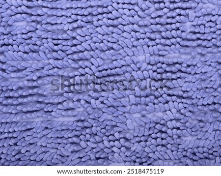 Closeup of a blue microfiber texture of a bath rug