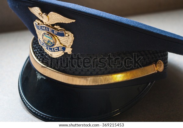 Closeup of\
a blue municipal Police Chief hat. \
Alaska.