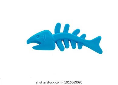 closeup blue rubber fish bone isolated on white background, top view dog and cat toy