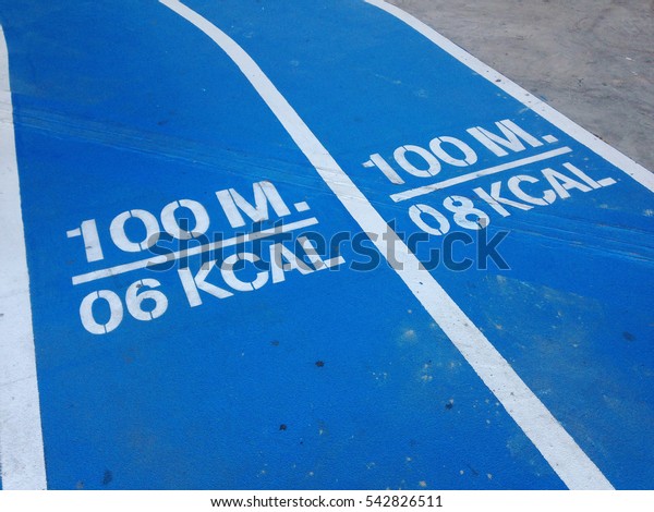 Close-up blue\
running track with motivation\
message