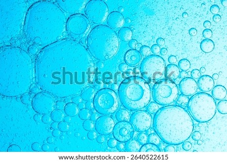 Close-up blue science experiment bubble texture,Bubbles in clear liquid, water or gel texture, oil drop, beauty collagen serum, hyaluronic essence skin care smear, aqua purity, abstract background.
