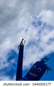 Closeup Of Blue Smiling Inflatable Tube Man Air Puppet Dancer With Clear Sky Background