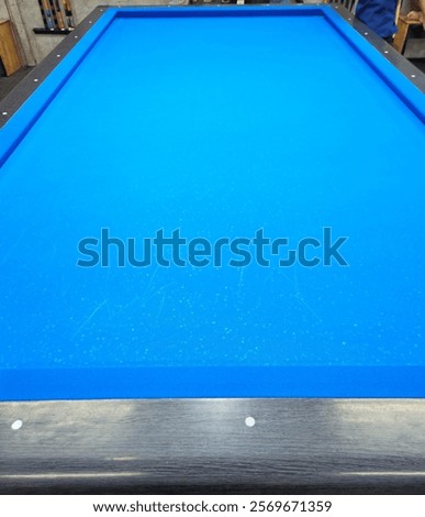 Close-up of the blue table of three cushion carom billiards.