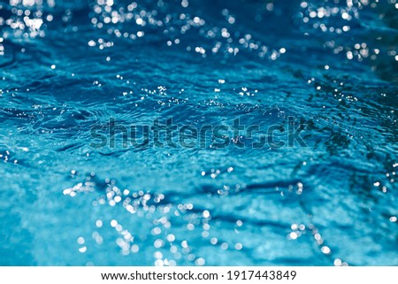 Close-up of blue water in the pool. Side view. Copy space.