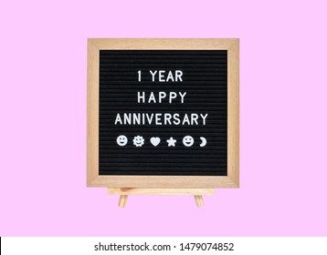 Closeup A Board With 1 Year Happy Anniversary Word Isolated On Pink Background