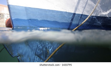 Close-up Of Boat Hull Taken With An Underwater Camera, Half Submerged