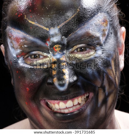 close-up body art - butterfly Totenkopf on the girl's face on a black background Studio 