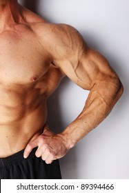 Closeup Of Body Builders Arm, Isolated On Grey