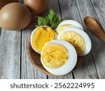 close-up of boiled eggs served on wooden plate.