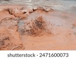 Closeup of boiling mud in Red Spouter geyser mud pot at Yellowstone National Park