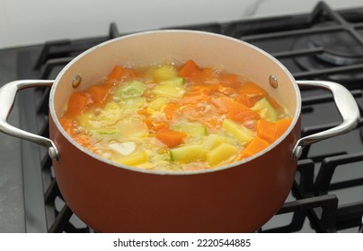 Closeup Of Boiling Pot Of Vegetable Soup On Stove Top. Vegetarian And Diet Food. Selective Focus