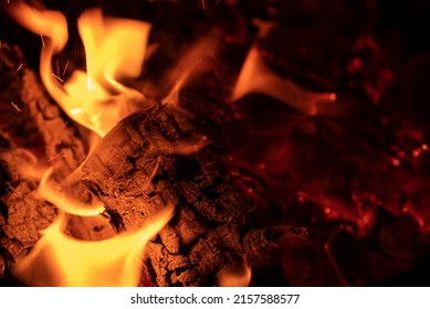 Close-up bonfire. Flames, ember and burning log of wood. Tranquil scene and leisure activity with family and friends.   - Powered by Shutterstock