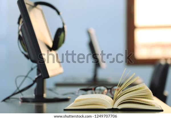 Closeup Book Opened On Computer Desk Stock Photo Edit Now 1249707706