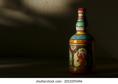 Close-up of a bottle painted in the traditional Patachitra style of Odisha, India, showing the Hindu god Ganesha