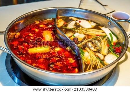Close-up of the bottom of traditional Chinese Sichuan hot pot, two flavors